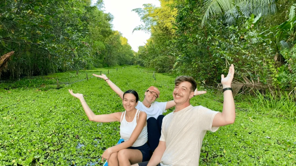 Tourists enjoying an eco boat tour through the Mekong Delta waterways in Vietnam