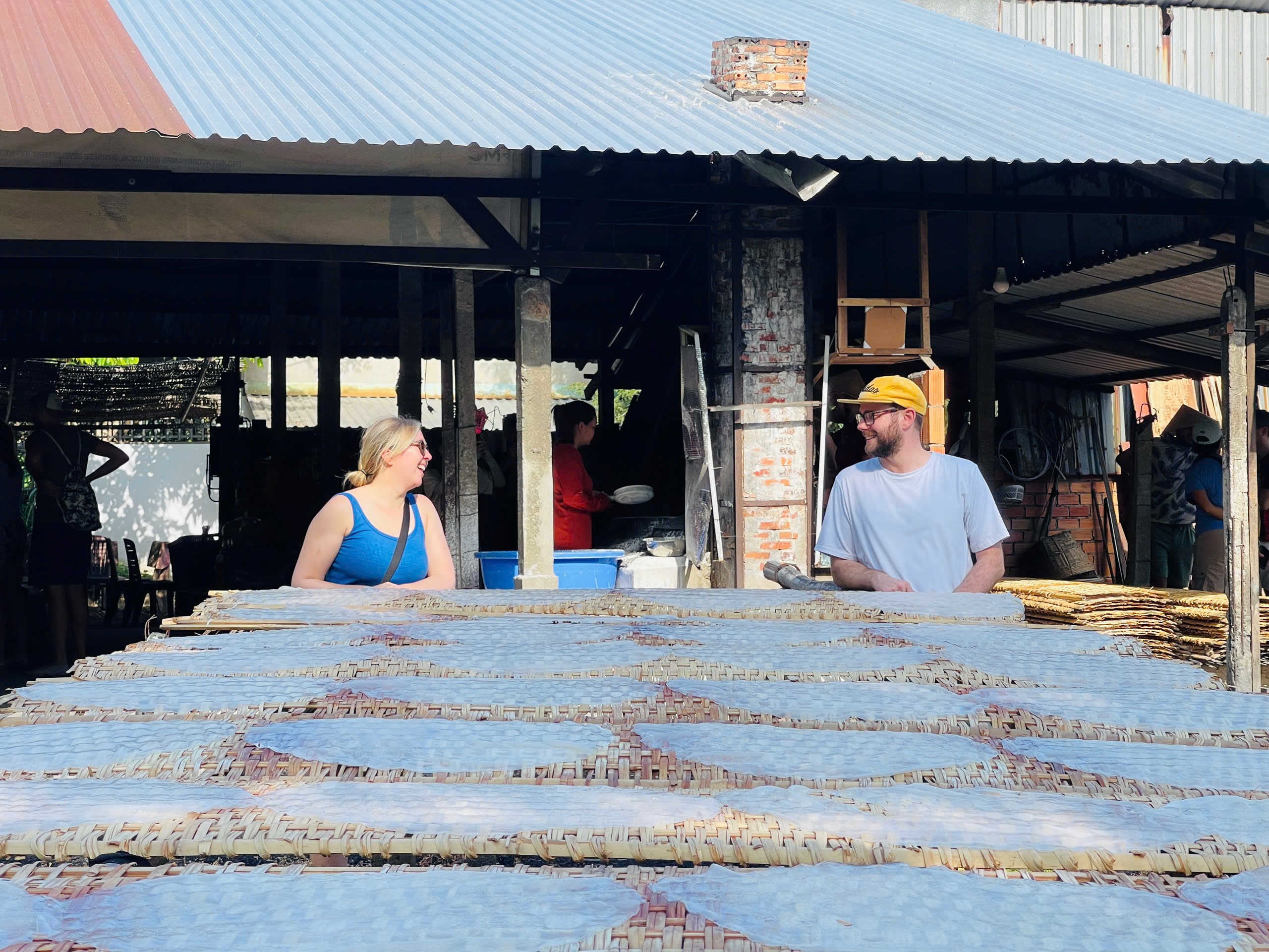 Tourists visiting a traditional rice paper village in the Mekong Delta, Vietnam.